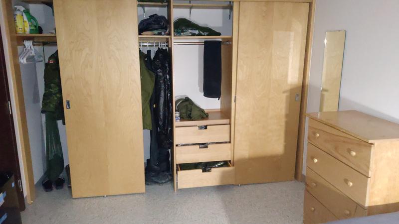 Aside from one pair of dress boots in their own protective bin, everything inside the furnishings in this photo fit in the four bins. All drawers are completely full.