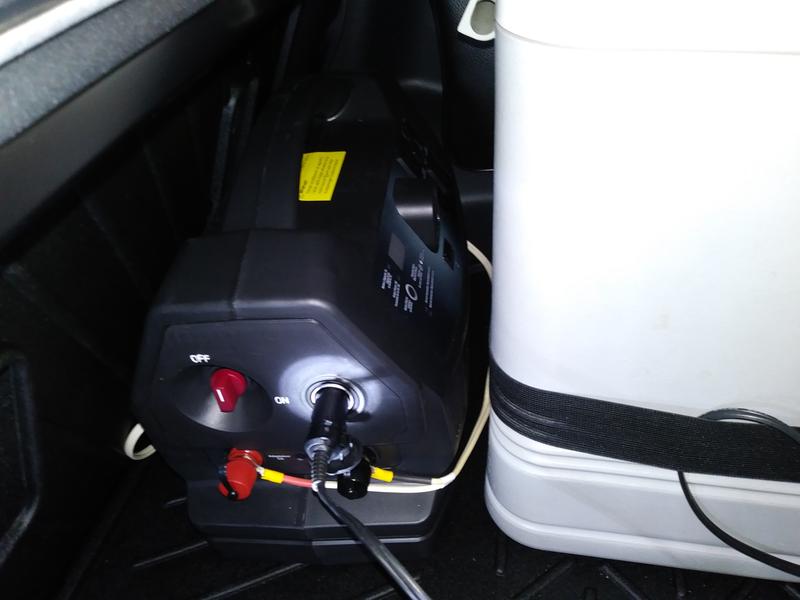 Unit in cargo area between back seat and cooler