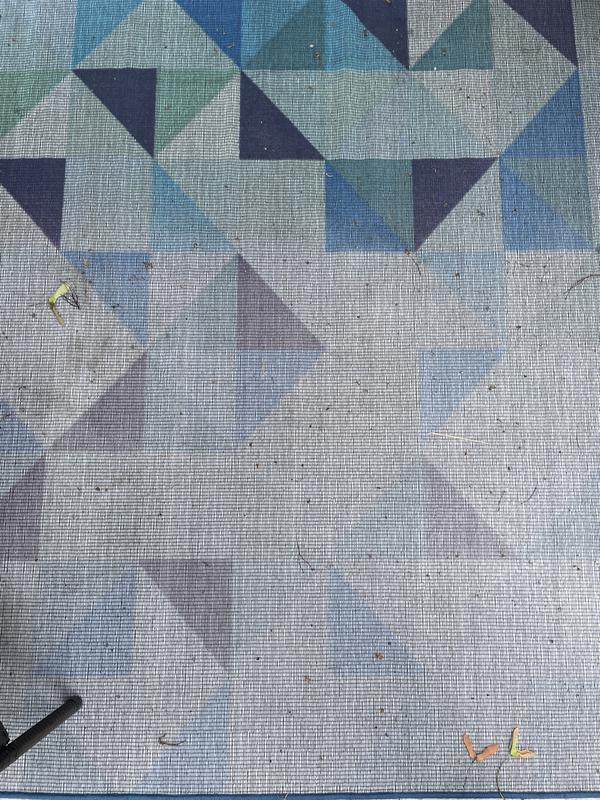 The brighter side is the part that has been covered by the conversation set and the faded part is the one facing the sun