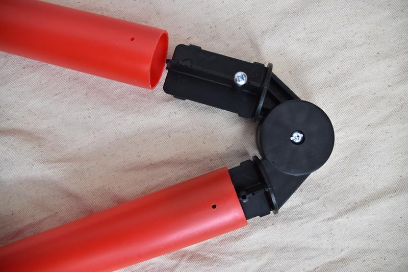 Adjustable bracket (a.k.a. hinge) showing pre-drilled holes in pipes that have to be lined up precisely with holes in hinge (one with screw to show location)