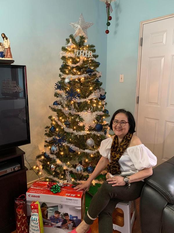 My 74 year old mom beside the tree from Canadian Tire.