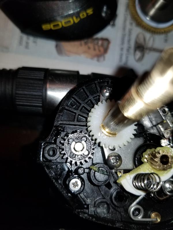 Broken tooth on black gear, stripped white gear