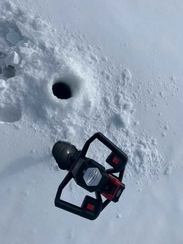 Drilled ice hole through 23cm (9") of ice