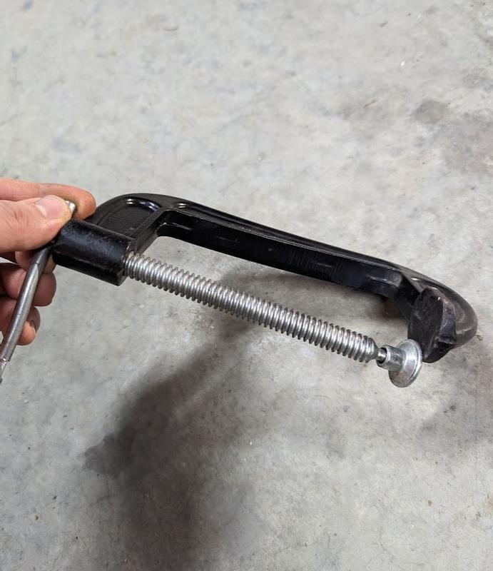 You can see how the clamp is twisted sideway and deformed so the bolt no longer lines up with the hook