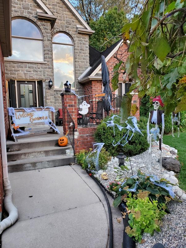 Shows start of false rock river.  Drain pipes hidden beneath rocks, all over the pond liner so the water runs down towards street rather then fondation.