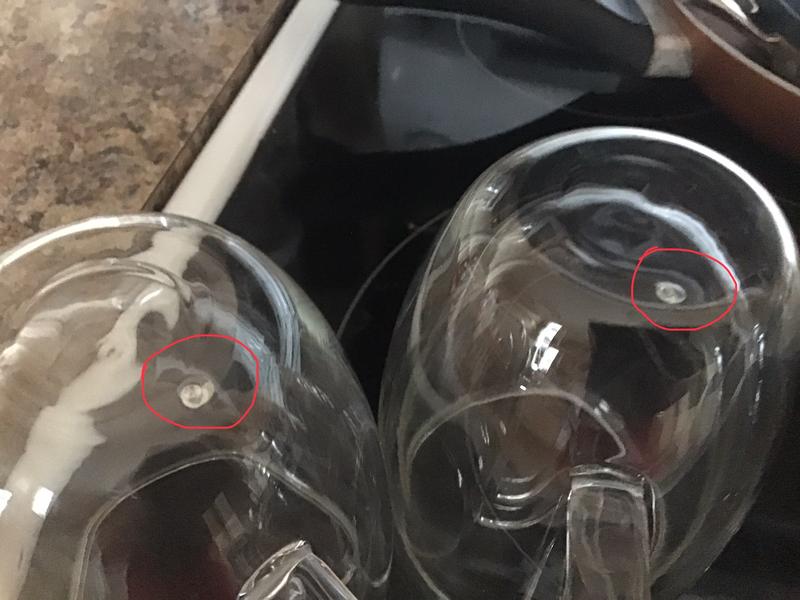 ..circled in red, one is raised and makes mug wobble on surface..