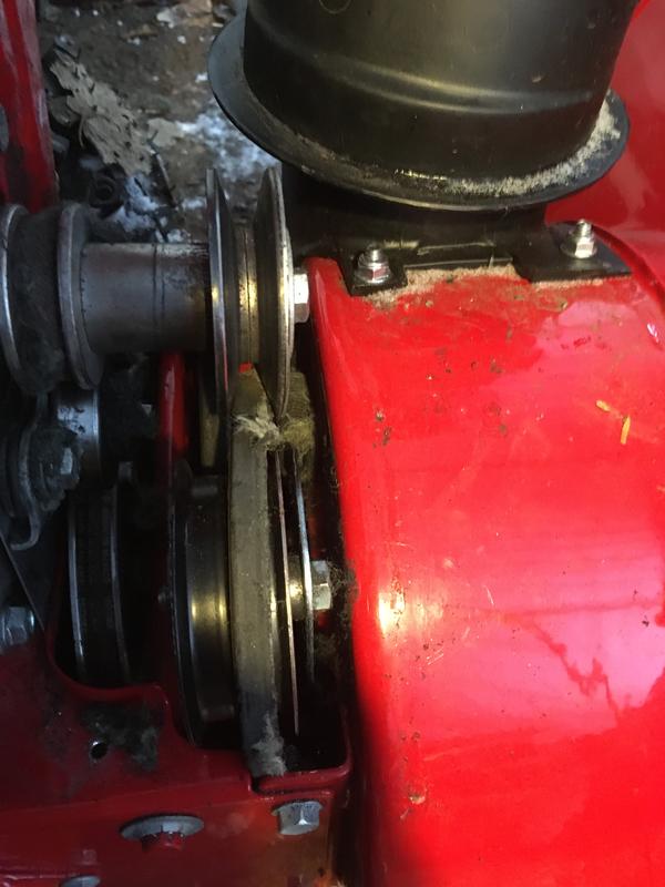 This is a new machine. Notice the shredded bits of auger belt in the assembly.
