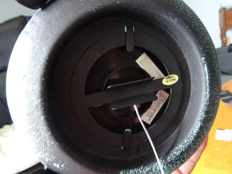 Round black plate does not slide out. Tabs are welded in position.