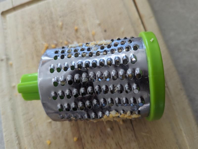 Warped & dented grating wheel. Results in plastic from the appliance mixing in the with the cheese.