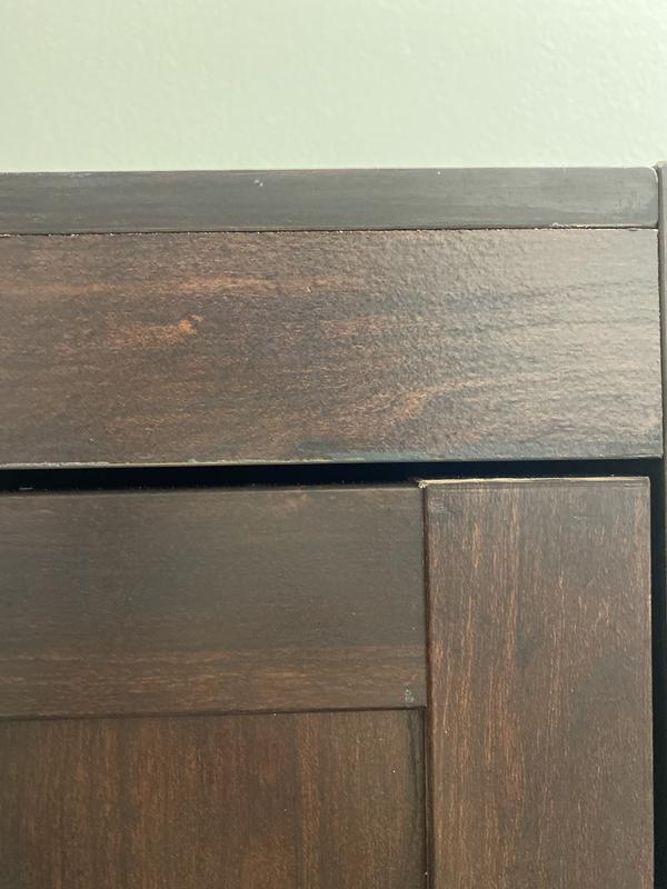 Edge where veneer doesn’t cover and paint was rubbed off.