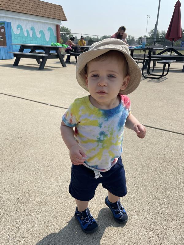 My son wearing carters sandals, hat and draw string shorts.