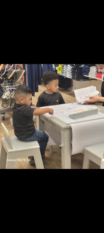 My sons just after arriving. Interacting with an employee at the drawing table.