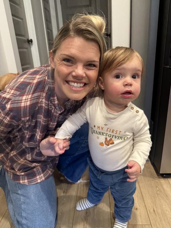 My son will be 1 year in a week and is wearing the 18 month onesie. He about 24-27lbs!