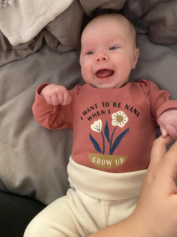 A baby who is very happy about her new onsie