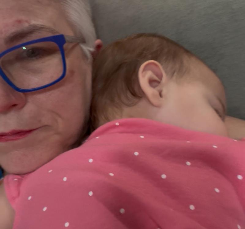 Happy girl snuggling in her new outfit with nana!