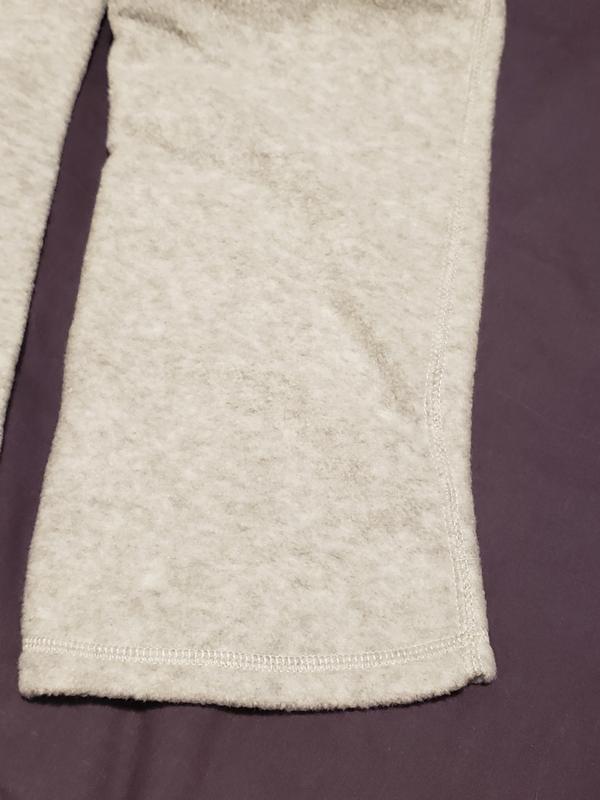 Curved seam on outside of pant leg.