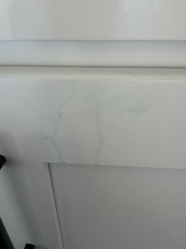 Green stain on white cupboard