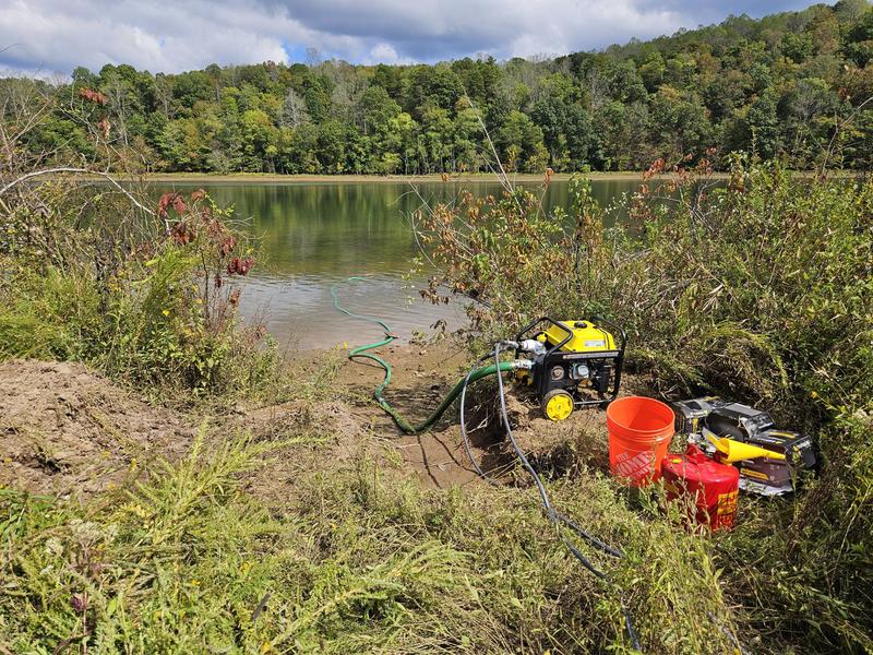 Pump setup with 65 ft. intake hose feeding two 100 ft. garden hoses.