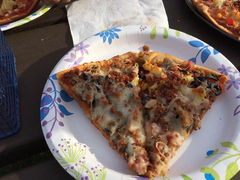 Pizza done on the cast iron griddle placed on the grill top