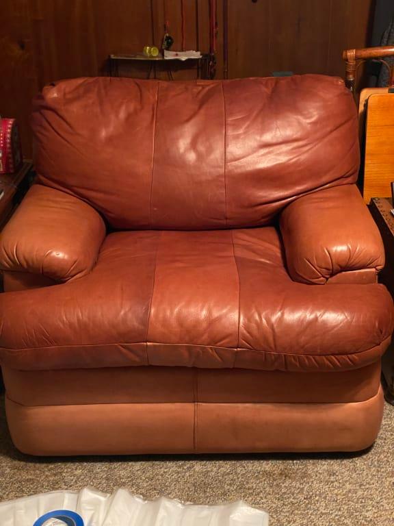 Clean and condition medium brown leather chair.