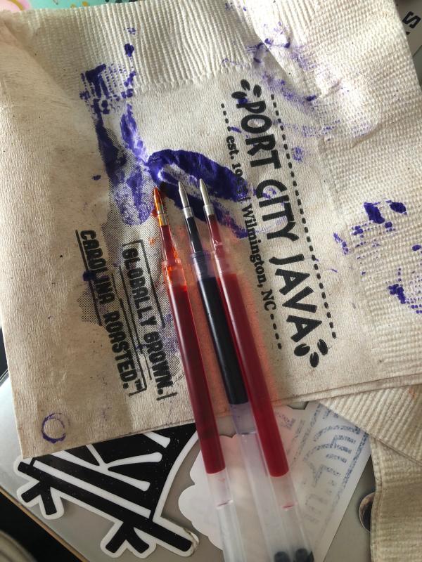 almost half of the purple pen is gone and the orange is leaking.