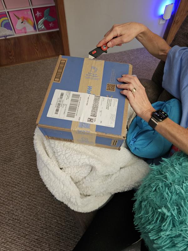 Knife cutting open a box