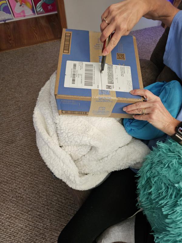 Knife being used to open a box