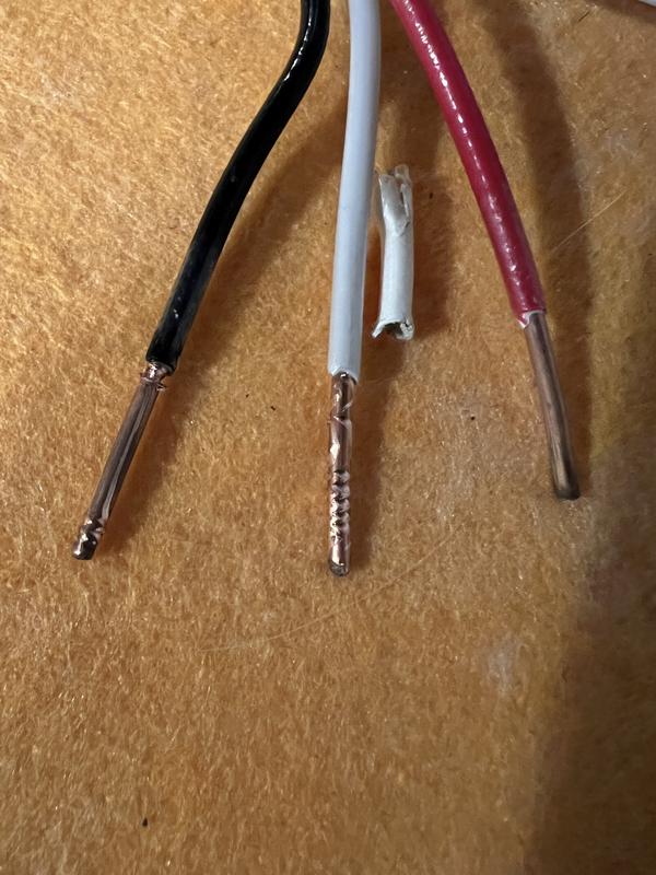 The black and white wires were stripped but the tool was not properly adjusted for the wire size. After adjusting the wires were  easily stripped and undamaged