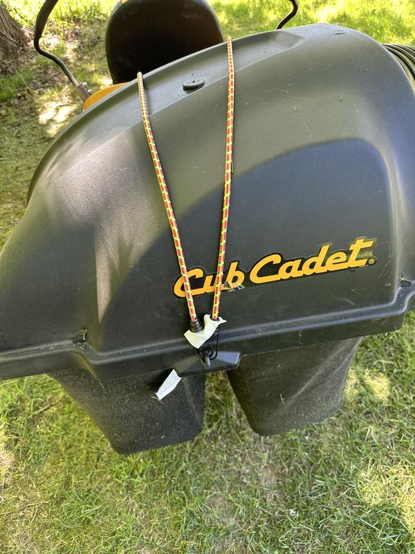 Purchase missing metal rod to easily lift bagger top on and off. Have to use bungie cords to prevent grass from coming out of the sides of the bagger