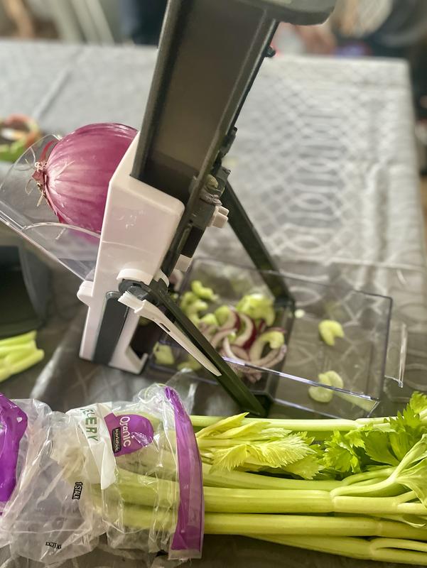 Celery and red onion being sliced