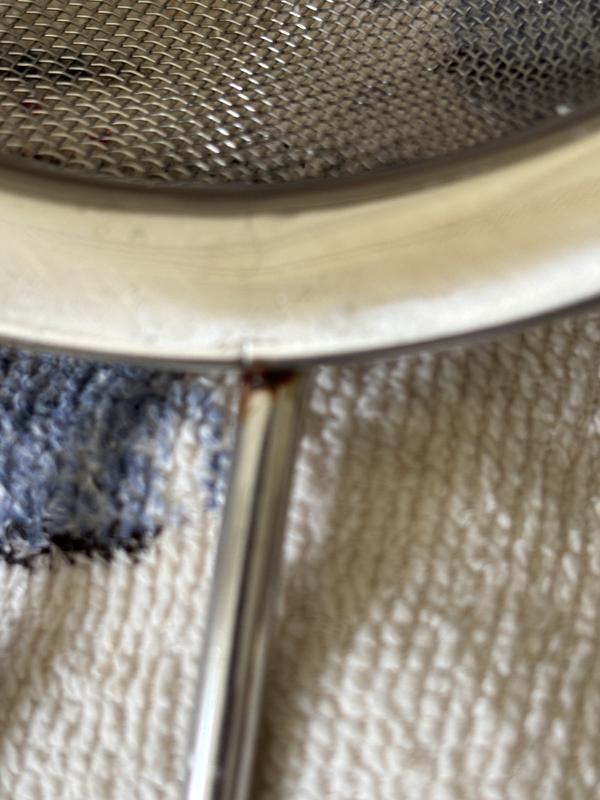 Rust where handle meets strainer