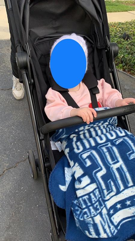 Baby on a walk, sitting up straight and enjoying the bar