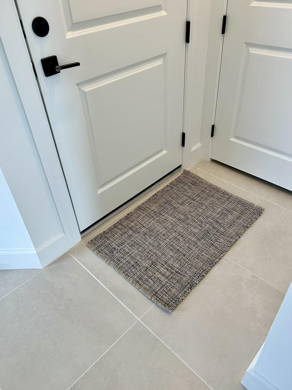 Rugs are close together in entryway.