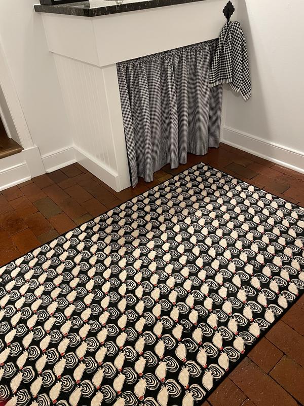 Great rug on red paver brick floor!