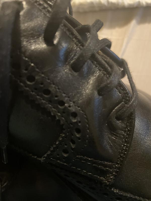 Customer photo for "Poor finish on upper part of shoes where laces are"