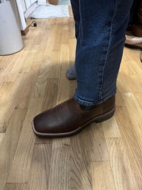 Boots tucked in and over the shaft with straight cut jeans.