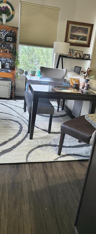 The rug fits beautifully between the back of the sofa and the adjoining wall with cabinet. I love it