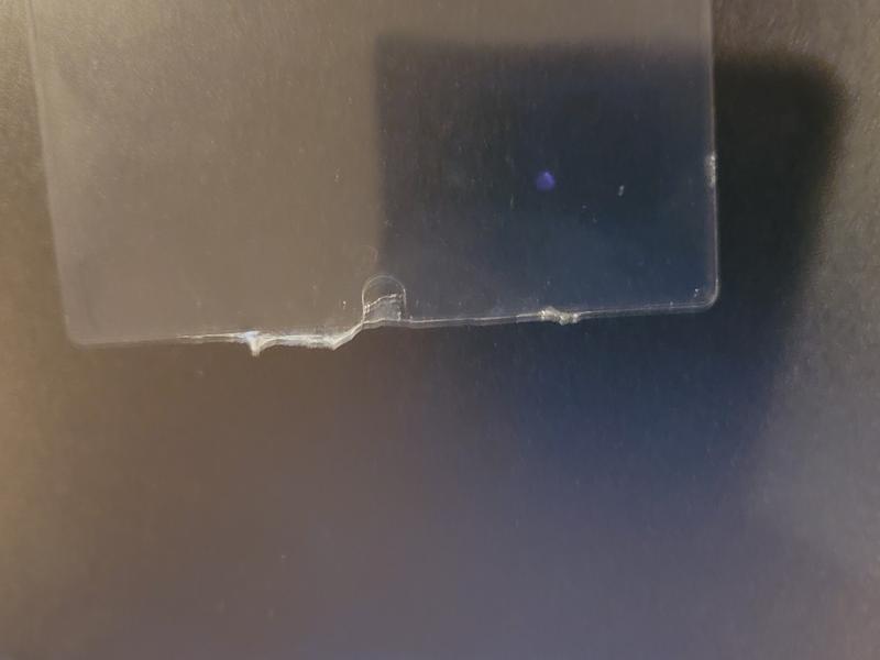 Edge of the screen protector after having to rip off one of the tabs.