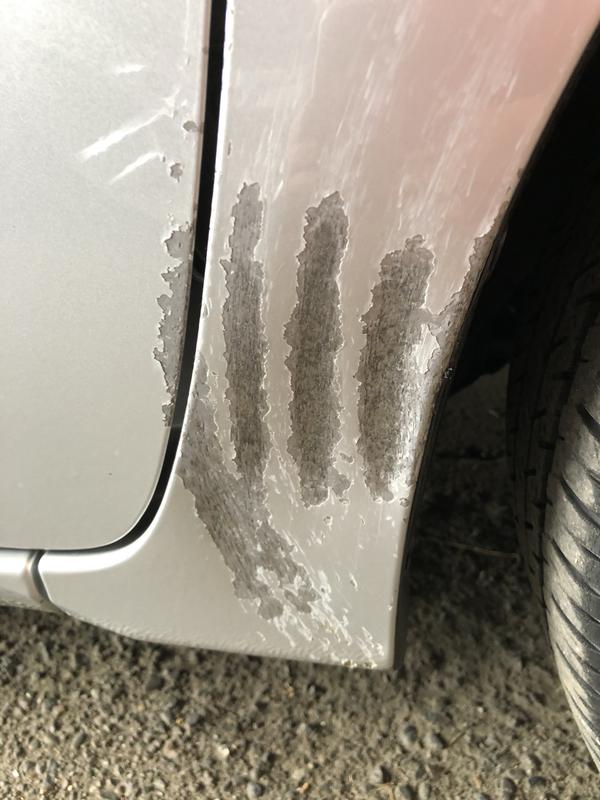 Close up tire damage to fender and door