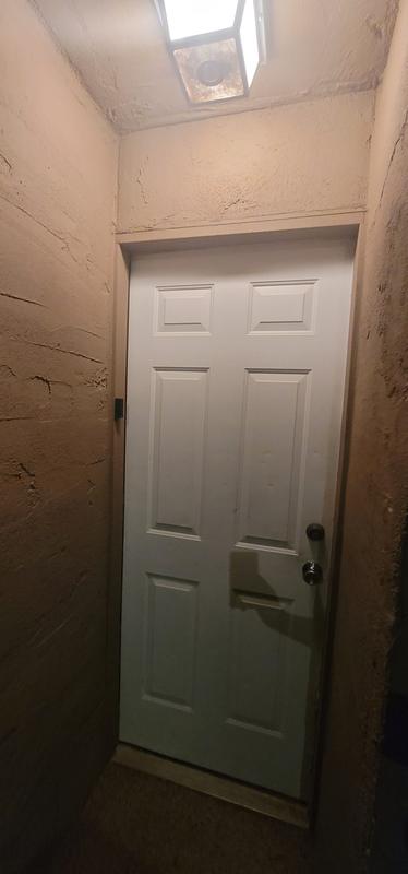Installed to left of door