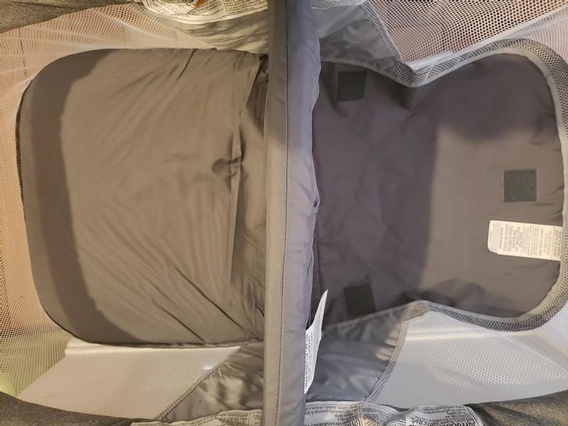 The padded base flips up on each side and you pull the handle in the middle to fold up the bassinet.