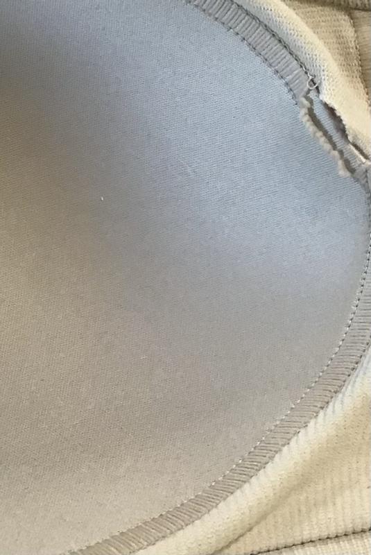 Tear inside, toward the center of bra.