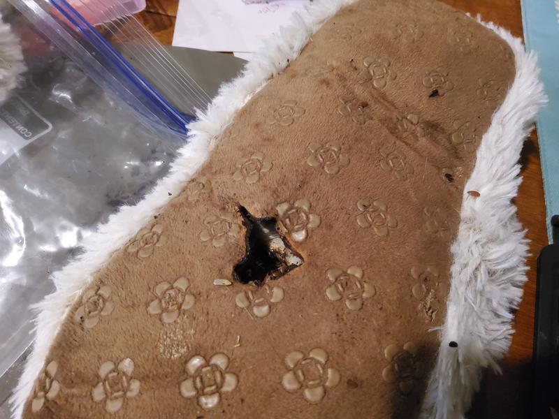 The bottom of the slipper that smouldered in the microwave. I've kept the item and the mat it burned in a plastic bag, and it still smells horrible.