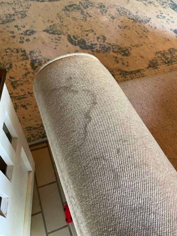 Very obvious stain on couch arm.