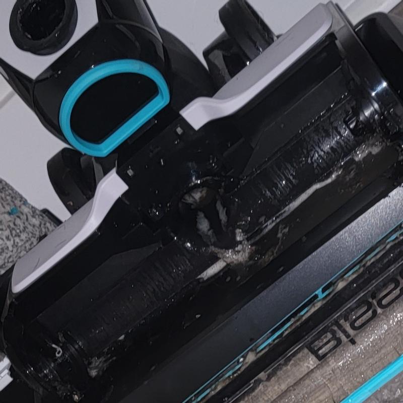 Spots on floor and excess water coming from hose.