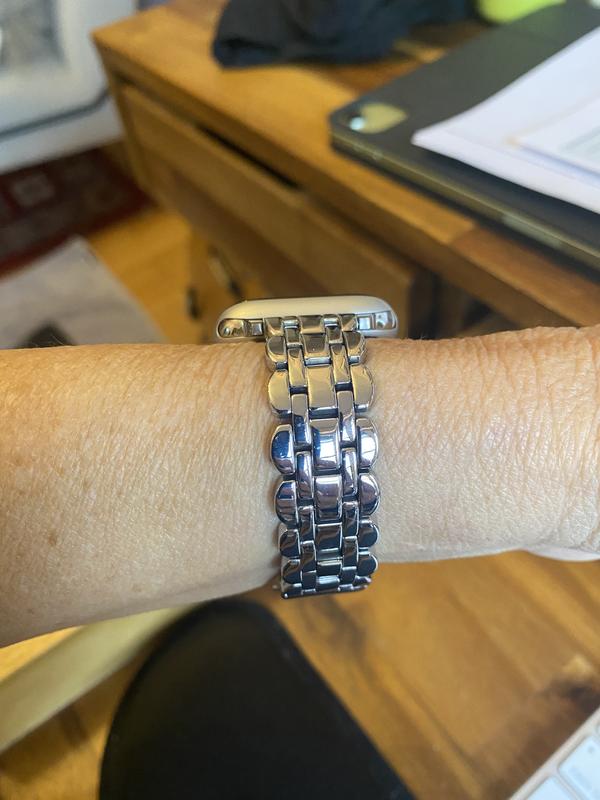 fits on small wrist easily by removing a few or the links. quick and easy.