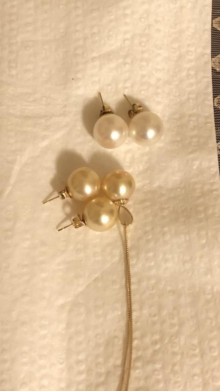 3 Gold pearls compared to 2 white pearls; the pendant gold pearl is oval-shaped and darker than the earrings
