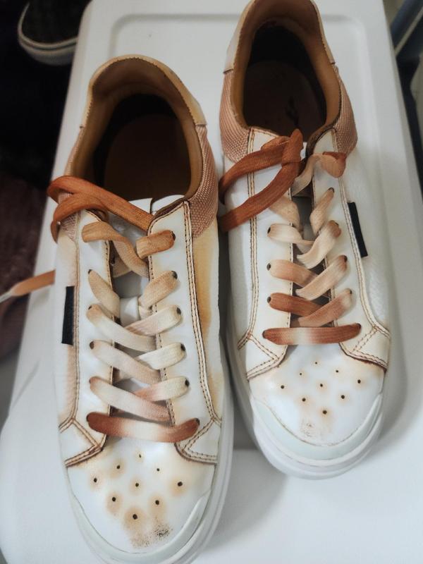 My new Tory Burch sneaker after two weeks and rainy day this is how it look. horrible shoe i want my money back..