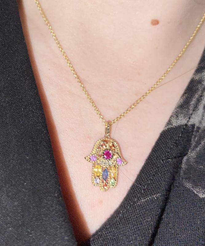 Notice that a stone is missing on the left side by the red ruby center stone.