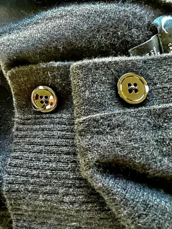 Chipped buttons on this cardigan sweater.